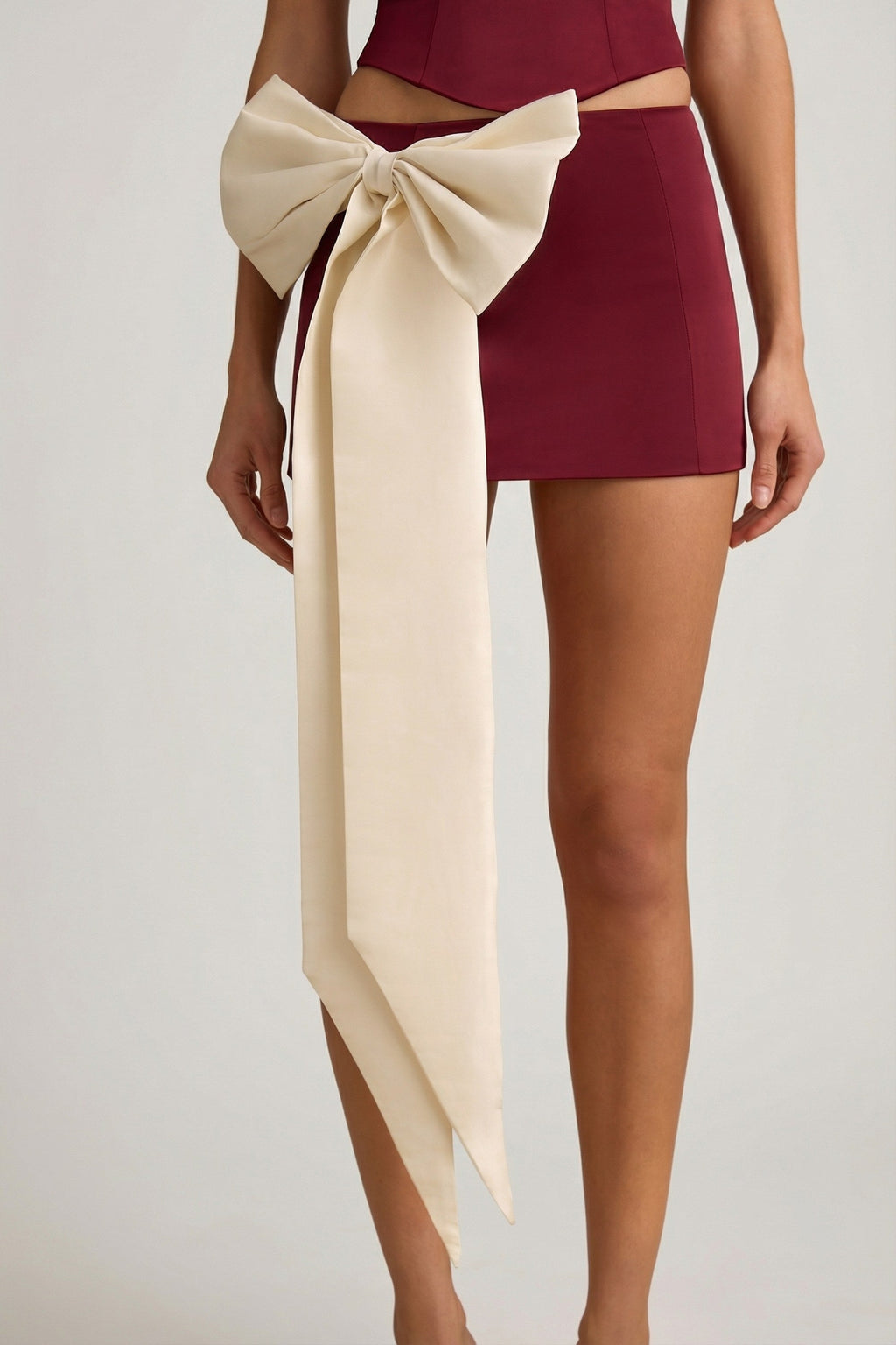 Satin Bow-Detail Low-Rise Mini Skirt in Wine Red