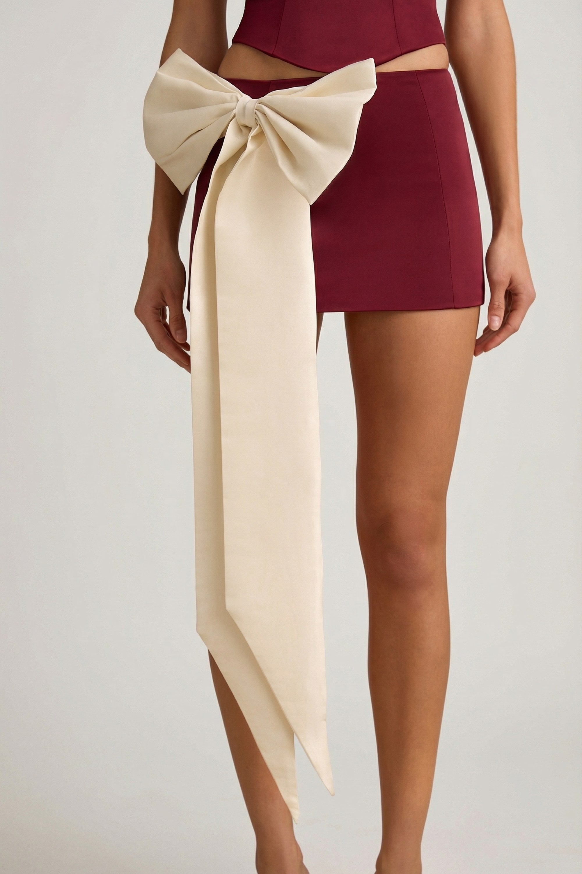 Satin Bow-Detail Low-Rise Mini Skirt in Wine Red